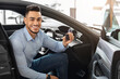 © Prostock-studio - Handsome arab man customer sitting in auto and holding key, smiling at camera, buying car in showroom. Cheerful middle-eastern guy sitting inside nice sports car, happy to get new automobile