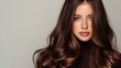 © mila103 - Young caucasian female with long brown hair and natural makeup.