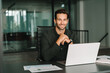 © Stock 4 You - Happy portrait young European business man ceo trader using laptop computer, working in office workplace. 30s middle-aged Hispanic smiling handsome businessman entrepreneur student looking at camera