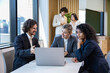© Akarawut - Team of diversity business people are discussing over the new strategic strategy project on investment real estate while working in modern office building for new project and planning
