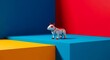 © Wahyudi Sukma - A small white and red robot dog stands on a blue block surrounded by vibrant primary colored walls and platforms.