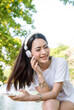 © aFotostock - Vertical Horizon Happy asian woman use headphones listen to music from smartphone outdoor travel on vacation. Vertical Music mental therapist for relax woman. Leisure cheerful wellness woman smile