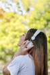© aFotostock - Vertical Horizon Happy asian woman use headphones listen to music from smartphone outdoor travel on vacation. Vertical Music mental therapist for relax woman. Leisure cheerful wellness woman smile