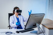 © Thitaporn - An Asian female doctor uses virtual reality controllers at a clinic desk, exploring immersive medical simulation, digital healthcare training, advanced technology applications, education, diagnosis
