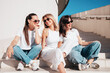 © halayalex - Three young beautiful smiling hipster female in trendy summer white t-shirt  and jeans clothes. Sexy carefree women posing in street. Positive models having fun, going crazy. In sunny day, sunglasses