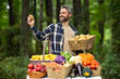 © Volodymyr - Hispanic Farmer with a basket full of fresh potatoes and carrots. Worker harvesting organic carrot, broccoli, peppers, and tomatoes. Man picking fresh pumpkins and melons during summer harvest.