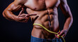 © Volodymyr - Fit man measures waist. Male muscular body shape. Sixpack abs define a lean waist. Slim waistline shows muscle definition. Waist measurement. Strong abs. Waist results from workout.