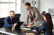 © Pixel-Shot - Male court mediator working with people at table in office