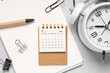 © Pixel-Shot - Calendar with alarm clock, notebook, pen, paper clip and binders on grey background