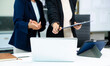 © Nuttapong punna - Business coworkers colleagues working together, have a discussion and using tablet and laptop computer at office with financial document on desk