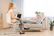 © Pixel-Shot - Teenage girl on sofa talking to psychologist in office