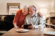 © Halfpoint - Elderly couple enjoying technology and spending time together.