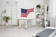 © Pixel-Shot - Interior of rehabilitation center with couch and hanging USA flag