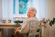 © Halfpoint - Senior woman smiling warmly on relaxed indoor portrait.