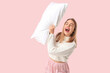 © Pixel-Shot - Beautiful young woman with white soft pillow on pink background