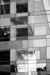 © yaqui_villegas - Abstract modern corporate architecture building facade of glass windows with mirrored grid reflections shaping an elegant geometry pattern