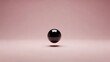 © LangkahKaki - A dark, glossy sphere levitating above a soft pink surface with a minimalist background.