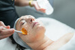 © Gonzalo Infiesta - Esthetician applying a chemical peel to client's face