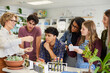 © Rido - Teacher showing science experiment to class at high school