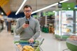 © Serhii - Handsome man shopping in a supermarket