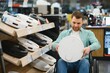 © Serhii - Man in wheelchair exploring electronics store aisle