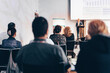 © kasto - Speaker giving a talk in conference hall at business event. Rear view of unrecognizable people in audience at the conference hall. Business and entrepreneurship concept