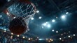 © horizon - Action shot captures a basketball going through the net with a swish moment and dramatic stadium lights in the background looking upwards.