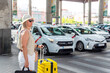 © Juanma Cuevas - Traveler woman waiting for taxi at station stand