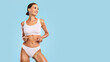 © Prostock-studio - Fitness, Skin Care Concept. Portrait Of Happy Slim Lady With Perfect Ideal Body Shape Posing Isolated On Blue Studio Background Looking Away Aside At Free Copy Empty Space For Advert, Banner, Panorama