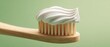 © Ksenia - The toothbrush with a swirl of fresh toothpaste on a bamboo handle