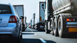 © Diroxn - Busy highway featuring a row of trucks, with cars and a clear sky creating a dynamic transportation scene.