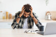 © Prostock-studio - Depressed arab man sitting in front of laptop at home, touching his head, suffering from burnout or financial crisis, young middle-eastern freelancer having problems at job, copy space