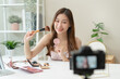 © Pormezz - Social media influencer beauty blogger concept, Young beautiful woman recording video review cosmetic and makeup tutorial.
