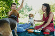© ADDICTIVE STOCK - Sisters enjoy a picnic with dogs in a sunny park