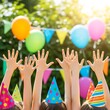© KB Kalmati - Brightly colored party hats and raised hands highlight a festive children's gathering in a beautiful sunlit outdoor backyard.