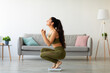 © Prostock-studio - Full length of excited Indian woman sitting on scales at home, overjoyed with success of her slimming diet, side view. Emotional Asian lady achieving her weight loss goal, making YES gesture