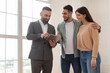 © Prostock-studio - Estimate Home Value. Portrait Of Couple Buying New Apartment, Professional Real Estate Agent In Suit Showing Digital Tablet With Build Project, Discussing House Plan, Selling Flat To Happy Family