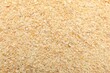 © New Africa - Granulated dried garlic as background, top view