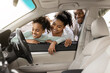 © Prostock-studio - Cheerful Black Family Of Three Buying New Car, Looking Through Window At Auto Interior Choosing Luxury Automobile In Dealership. Vehicle Rent And Purchase Concept