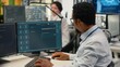 © DC Studio - Programmer in office using AI LLM chatbot to get help optimizing systems performance metrics. IT worker in tech agency utilizing generative AI LLM assistant for faster software development, camera B