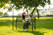 © Wasana - Mother and son relaxing in park enjoying family time