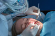 © Tatiana - Dentist examining patient teeth during routine dental checkup. Close-up of professional oral examination with dental mirror and probe in a modern clinic, preventive care and oral health concept.