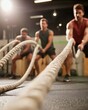 © Breezze - Group of men performing battle rope exercises in a fitness gym, engaging in training for strength and coordinated effort, ideal for promoting group fitness classes