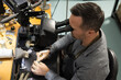 © Austockphoto - A jeweller looking through a scope while working on a piece of jewellery