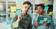 © WesJVR/peopleimages.com - Writing, tablet and business men in meeting for brainstorming, planning or project agenda. Creative office, glass board and people on digital tech for research, schedule or seo review on sticky notes
