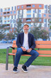 © Sergio León - Casual Businessman Relaxing On Orange Park Bench In Urban City Park