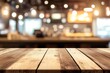 © Kristina - Empty wooden table in fast food restaurant setting with bright lights in background at lunch time for people to gather and eat