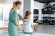 © zinkevych - Woman therapist working with girl during rehab session