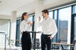 © zinkevych - Man and woman working together in the office and looking busy and involved