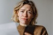 © RaptorWoman - A person looks confused, holding a letter and smartphone, possibly dealing with unexpected news or bills.